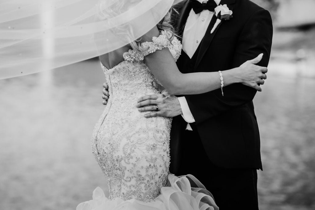 black and white photography groom bride kissing 